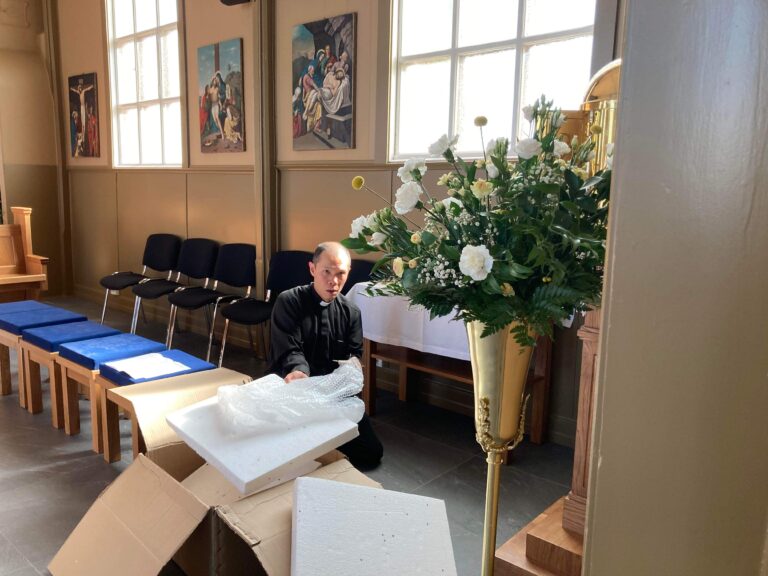 p.Khime pakker (spent og forventningsfullt) opp apostelkorsene.